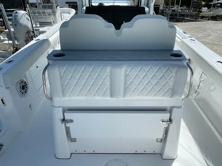 Ice Blue Yacht Photos Pics 2024 Everglades 285CC boat interior with cushioned seating and storage.