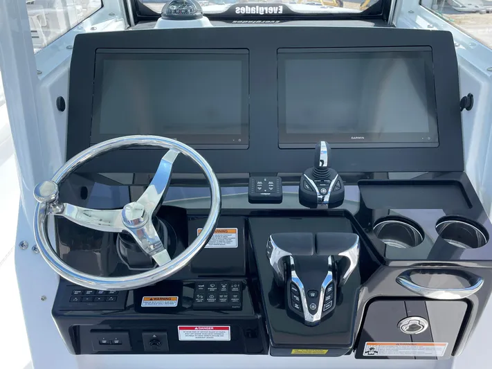 Ice Blue Yacht Photos Pics 2024 Everglades 285CC boat dashboard with dual screens and steering wheel.
