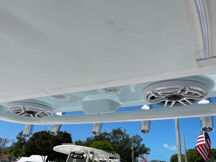 Ice Blue Yacht Photos Pics Speakers and rod holders on 2024 Everglades 285CC boat, under clear blue sky.