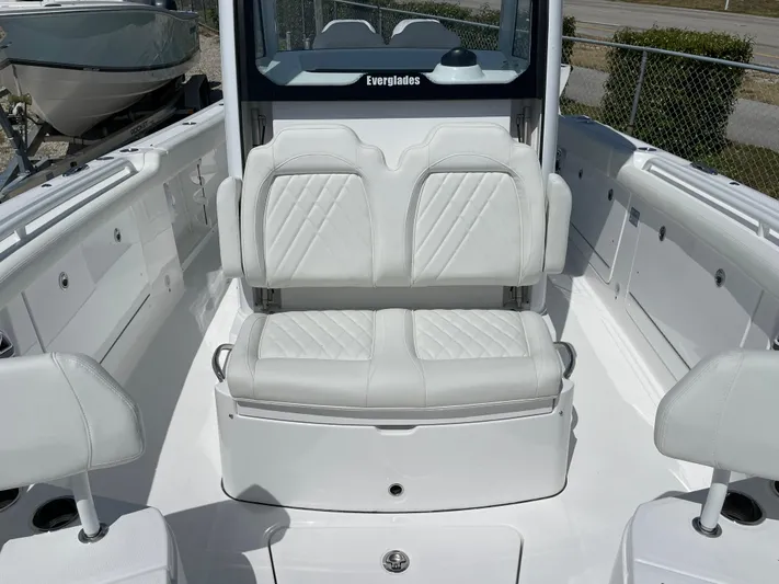 Ice Blue Yacht Photos Pics 2024 Everglades 285CC boat interior with white cushioned seating and sleek design.