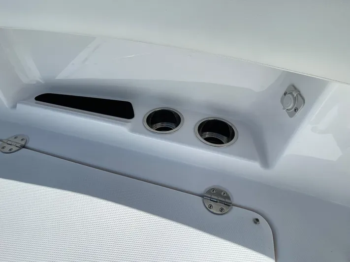 Ice Blue Yacht Photos Pics 2024 Everglades 285CC boat interior detail with cup holders and storage compartment.