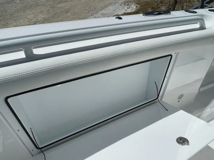 Ice Blue Yacht Photos Pics 2024 Everglades 285CC boat interior detail with open storage compartment.