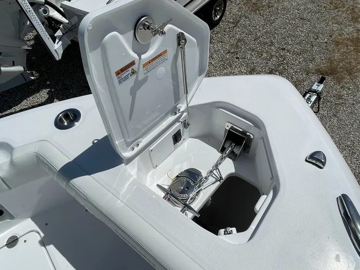 Ice Blue Yacht Photos Pics 2024 Everglades 285CC boat anchor compartment with open hatch, showcasing storage and mechanism.