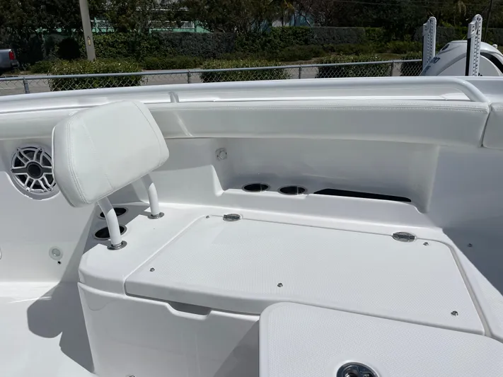Ice Blue Yacht Photos Pics 2024 Everglades 285CC boat interior with white seating and speaker detail.
