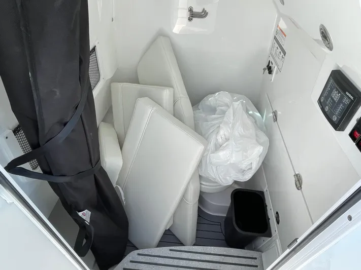 Ice Blue Yacht Photos Pics 2024 Everglades 285CC boat interior storage with cushions and equipment.