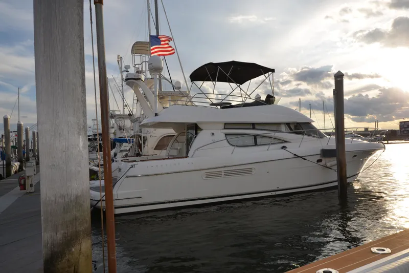 Piper Yacht Photos Pics 2007 Jeanneau Prestige 46 yacht docked at marina during sunset.