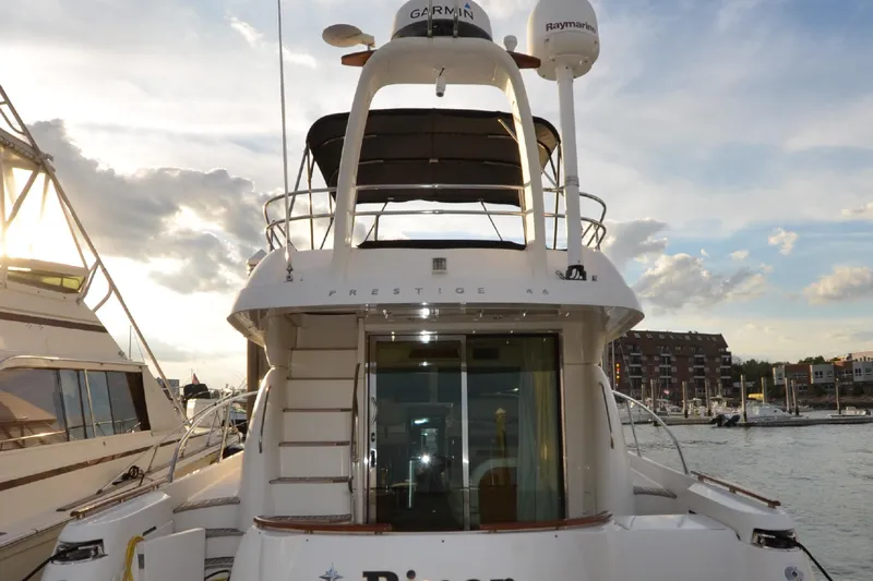 Piper Yacht Photos Pics 2007 Jeanneau Prestige 46 yacht docked, showcasing rear view with elegant design and modern equipment.