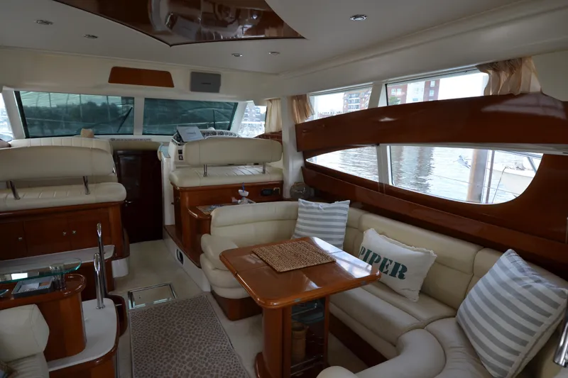 Piper Yacht Photos Pics Luxurious interior of 2007 Jeanneau Prestige 46 yacht with elegant seating and large windows.