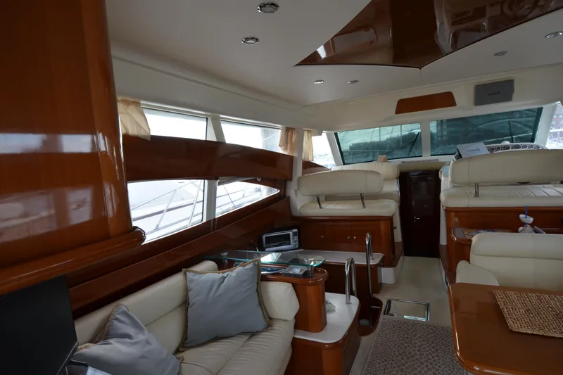 Piper Yacht Photos Pics Luxurious interior of a 2007 Jeanneau Prestige 46 yacht with elegant seating and wood finishes.