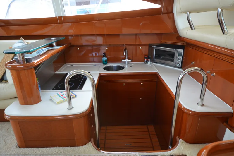 Piper Yacht Photos Pics Luxurious kitchen interior of 2007 Jeanneau Prestige 46 yacht with modern amenities.