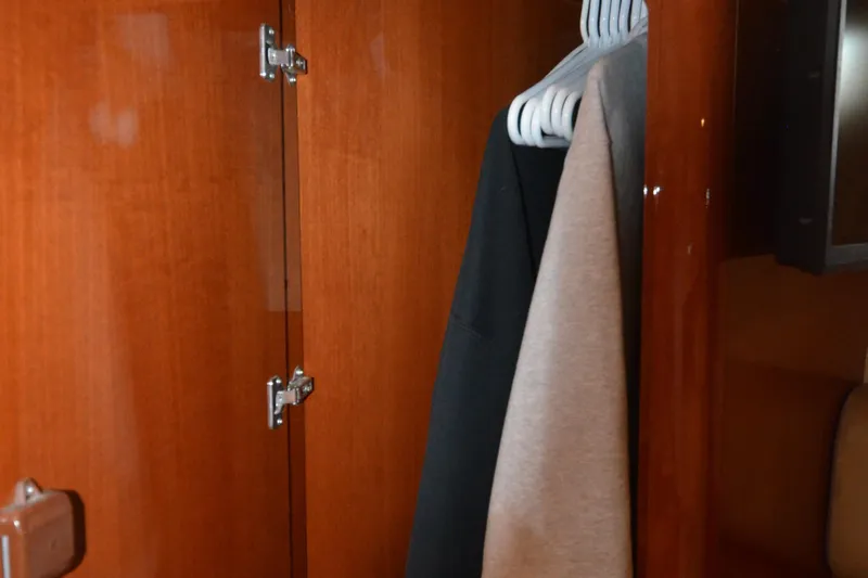 Piper Yacht Photos Pics Wooden closet interior on a 2007 Jeanneau Prestige 46 yacht with hanging clothes.