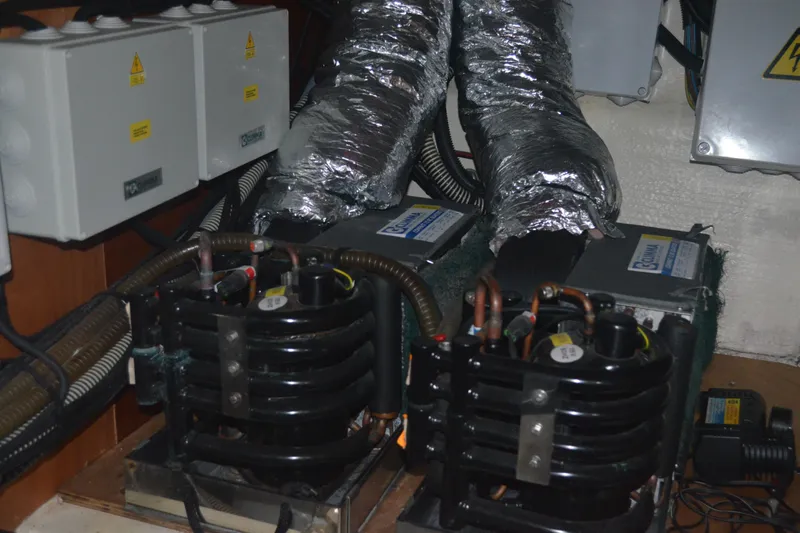 Piper Yacht Photos Pics Engine room of 2007 Jeanneau Prestige 46 yacht with cooling systems and electrical components.