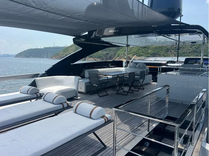 Hk 007 Yacht Photos Pics Luxurious 2024 Riva 102' Corsaro Super yacht deck with sun loungers and dining area.