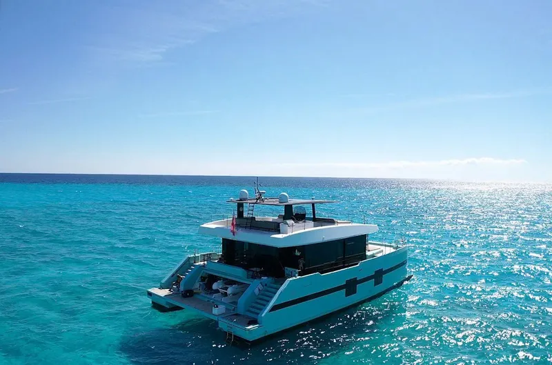 Rockstar 2.0 Yacht Photos Pics Luxurious 2018 Sunreef 68 Supreme yacht cruising on clear blue ocean waters.