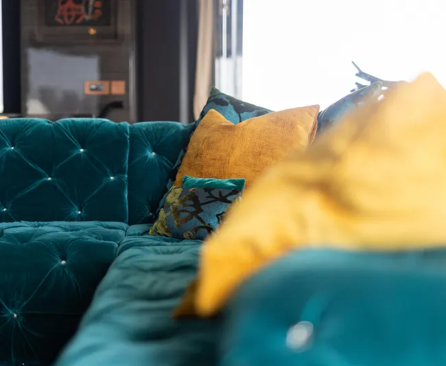 Rockstar 2.0 Yacht Photos Pics Luxurious teal sofa with vibrant yellow and blue cushions on Sunreef 68 Supreme yacht, 2018.