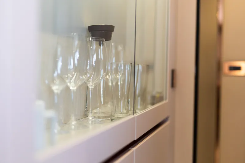 Rockstar 2.0 Yacht Photos Pics Glassware in cabinet aboard 2018 Sunreef 68 Supreme yacht interior.