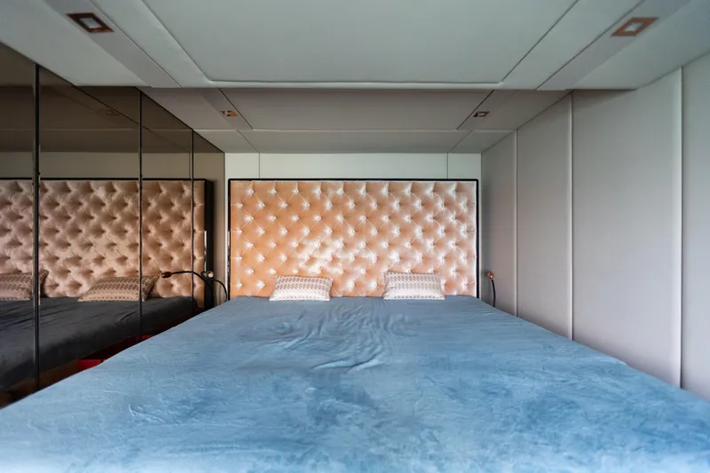 Rockstar 2.0 Yacht Photos Pics Luxurious bedroom interior on 2018 Sunreef 68 Supreme yacht with tufted headboard and mirrored walls.