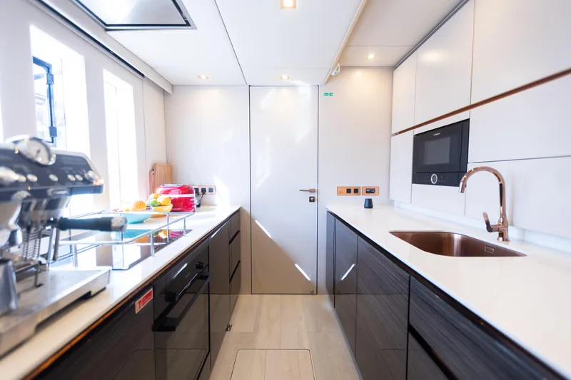 Rockstar 2.0 Yacht Photos Pics Modern kitchen interior on 2018 Sunreef 68 Supreme yacht, featuring sleek design and appliances.