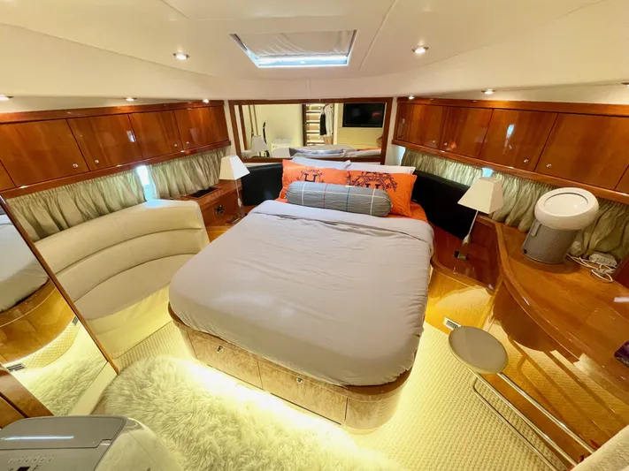 Ellyn Yacht Photos Pics Luxurious Sunseeker Manhattan 70 yacht bedroom, 2010 model, featuring elegant wood finishes and modern lighting.