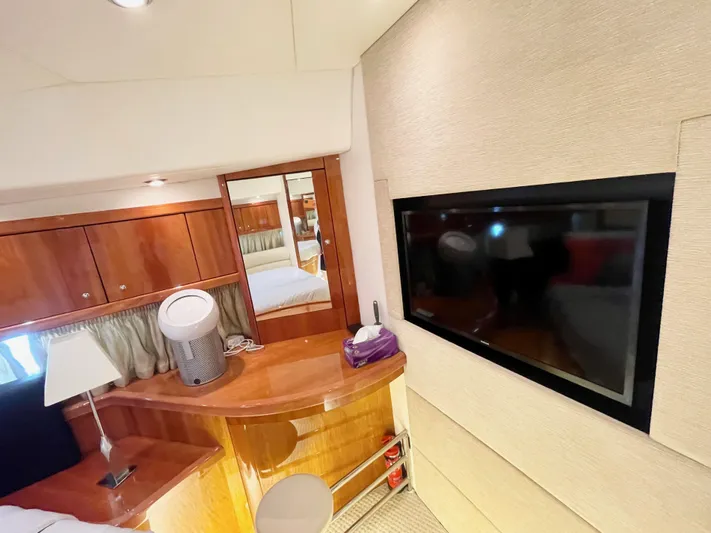Ellyn Yacht Photos Pics Luxurious cabin interior of 2010 Sunseeker Manhattan 70 yacht with TV and wooden furnishings.