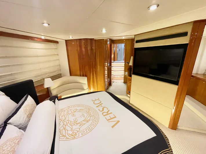 Ellyn Yacht Photos Pics Luxurious Sunseeker Manhattan 70 yacht bedroom with Versace bedding, elegant wood finishes, and modern decor.