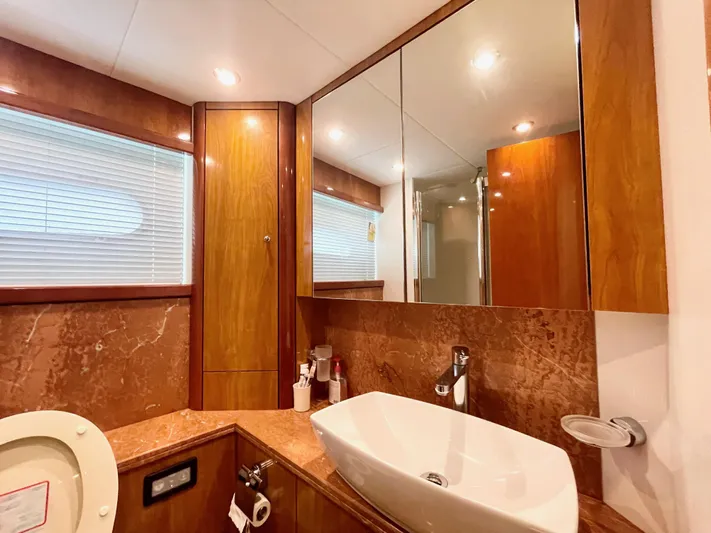 Ellyn Yacht Photos Pics Luxurious bathroom in 2010 Sunseeker Manhattan 70 yacht with wood accents and modern fixtures.