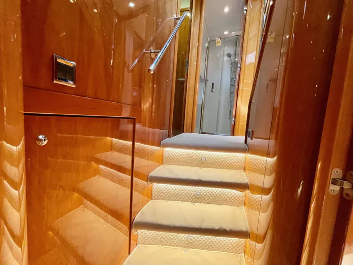 Ellyn Yacht Photos Pics Luxurious interior staircase of 2010 Sunseeker Manhattan 70 yacht, featuring polished wood finish.