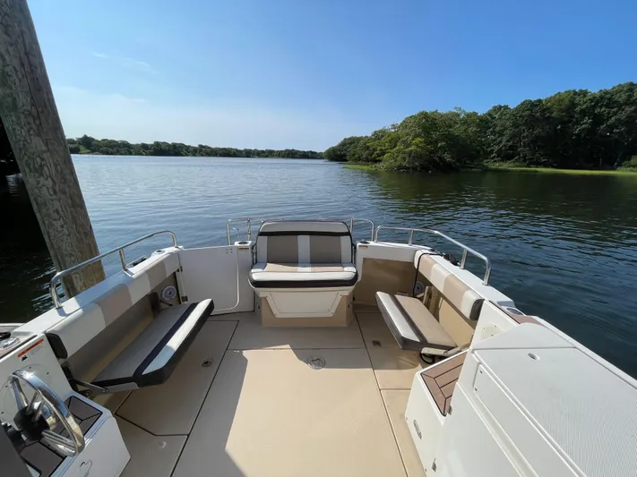  Yacht Photos Pics 2017 Cutwater C-28 boat interior with seating, docked on a serene lake.