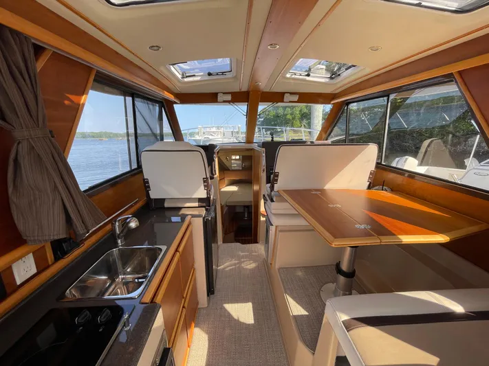  Yacht Photos Pics Interior of 2017 Cutwater C-28 boat with dining area and kitchenette.