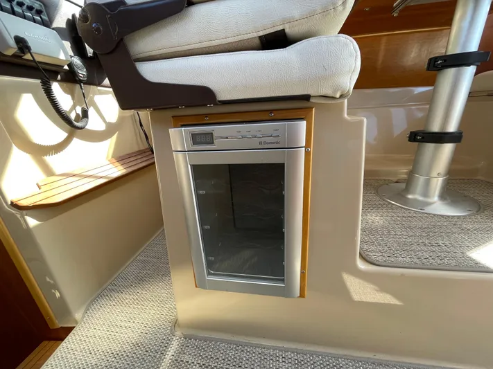  Yacht Photos Pics Captain's chair and Dometic fridge in 2017 Cutwater C-28 boat interior.