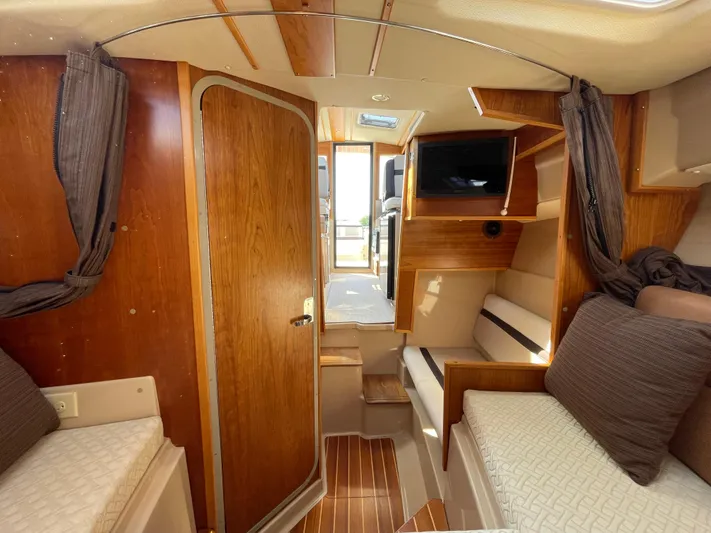  Yacht Photos Pics 2017 Cutwater C-28 cabin interior with wood finish, seating, and TV.