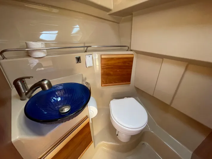  Yacht Photos Pics 2017 Cutwater C-28 boat bathroom with blue glass sink and modern fixtures.