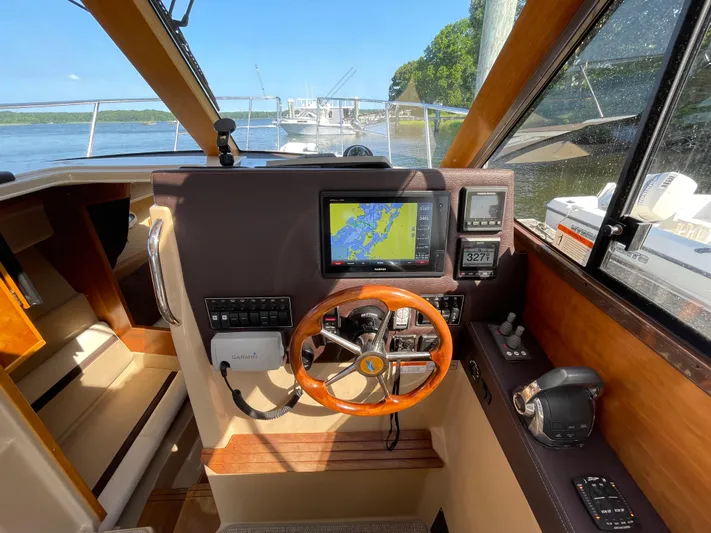  Yacht Photos Pics Interior view of 2017 Cutwater C-28 boat cockpit with navigation system and steering wheel.