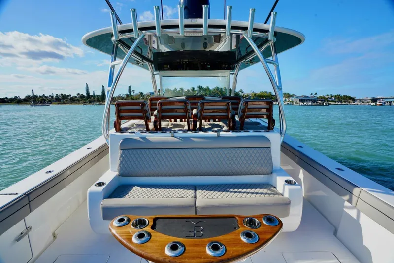 Rhyde Yacht Photos Pics 2021 Valhalla Boatworks V46 on water, featuring luxurious seating and fishing rod holders.