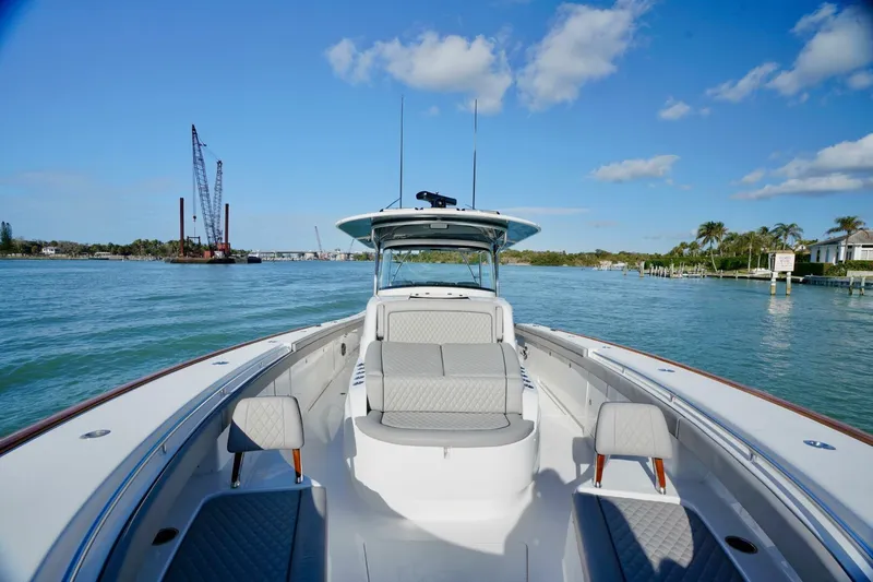 Rhyde Yacht Photos Pics 2021 Valhalla Boatworks V46 on calm water, clear sky, and coastal backdrop.