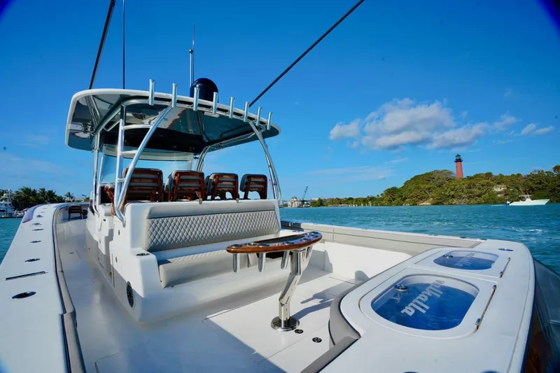 Rhyde Yacht Photos Pics 2021 Valhalla Boatworks V46 on water, lighthouse in background, clear blue sky.