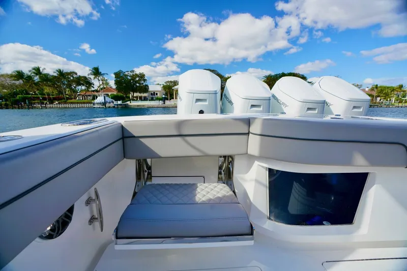 Rhyde Yacht Photos Pics 2021 Valhalla Boatworks V46 with quad Mercury engines, luxurious seating, and scenic waterfront view.