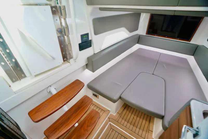 Rhyde Yacht Photos Pics 2021 Valhalla Boatworks V46 interior cabin with modern seating and wooden steps.