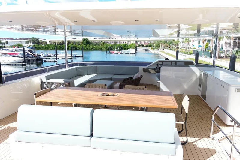 Paso Doble Yacht Photos Pics Luxurious Granocean W72 yacht deck with seating, table, and marina view, 2025 model.