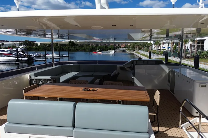 Paso Doble Yacht Photos Pics Luxurious Granocean W72 yacht deck with seating, table, and scenic marina view, 2025 model.