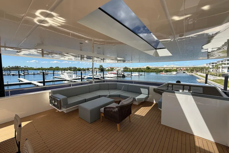 Paso Doble Yacht Photos Pics Luxurious Granocean W72 yacht interior with modern seating, overlooking marina, 2025 model.