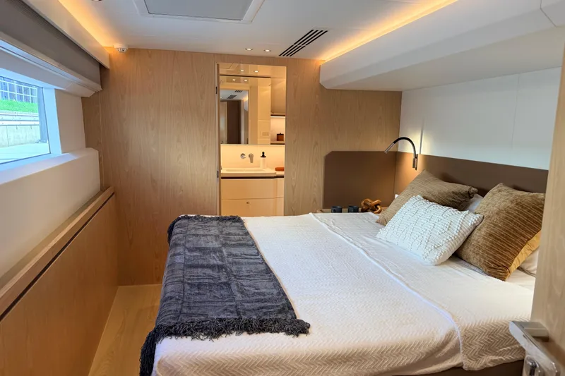 Paso Doble Yacht Photos Pics Luxurious Granocean W72 yacht bedroom interior, featuring modern design and cozy bedding, 2025 model.