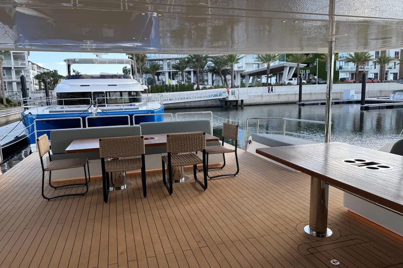 Paso Doble Yacht Photos Pics Luxurious Granocean W72 yacht deck with elegant seating, docked in a serene marina, 2025 model.