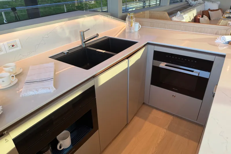 Paso Doble Yacht Photos Pics Modern kitchen on Granocean W72 yacht, featuring sleek countertops, sink, and built-in appliances, 2025 model.