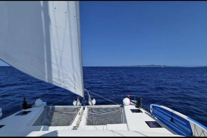Kuala Yacht Photos Pics Sailing on a 2015 Lagoon 52 catamaran in open blue sea under clear skies.