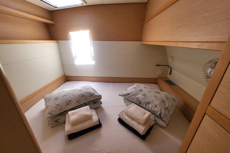 Kuala Yacht Photos Pics Cozy cabin interior of 2015 Lagoon 52 yacht with neatly arranged bedding.