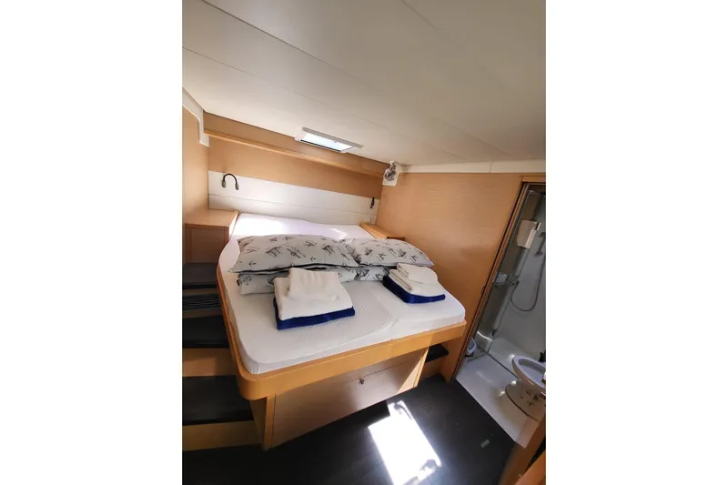 Kuala Yacht Photos Pics Luxurious cabin interior of 2015 Lagoon 52 yacht with cozy bed and modern amenities.