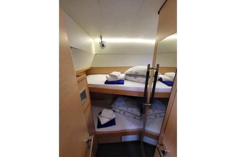 Kuala Yacht Photos Pics Cozy cabin interior of 2015 Lagoon 52 yacht with bunk beds and soft lighting.
