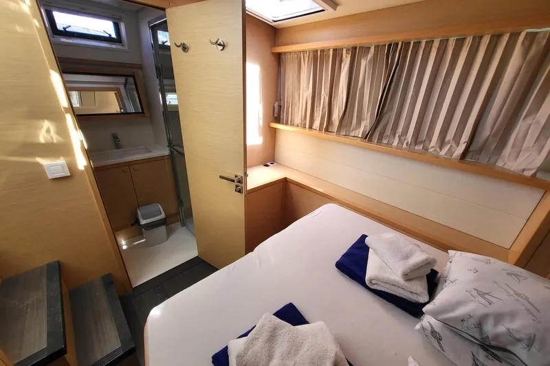 Kuala Yacht Photos Pics Luxurious cabin interior of 2015 Lagoon 52 yacht with bed and ensuite bathroom.