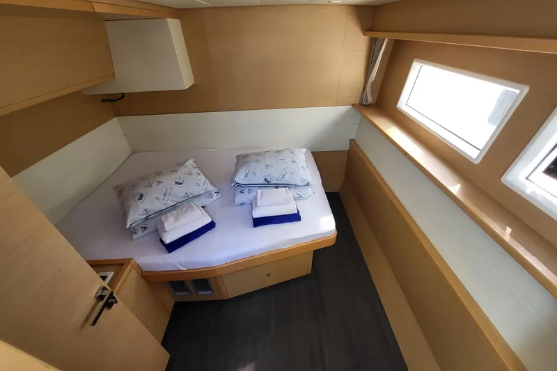 Kuala Yacht Photos Pics Interior cabin of 2015 Lagoon 52 yacht with bed and windows.